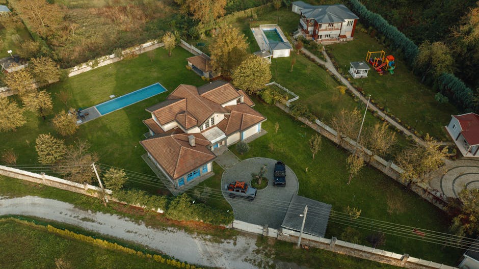 Aerial shot of suburban houses with pools in İzmit, Kocaeli, Türkiye, showcasing spacious lawns.