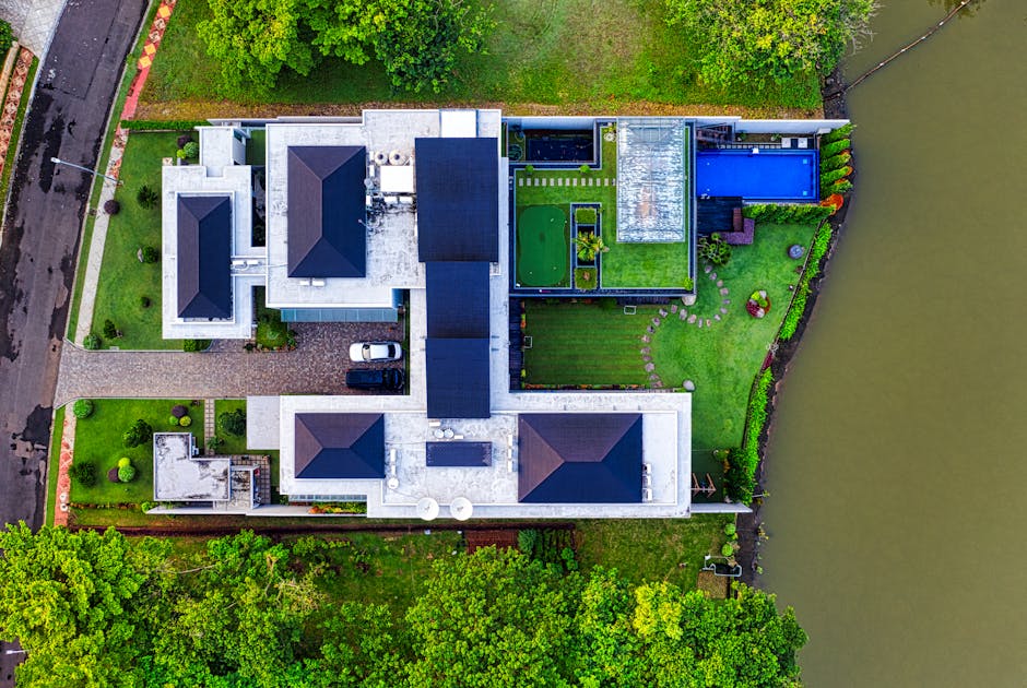 A stunning aerial view of a modern mansion in Banten, Indonesia, showcasing its architectural design and scenic surroundings