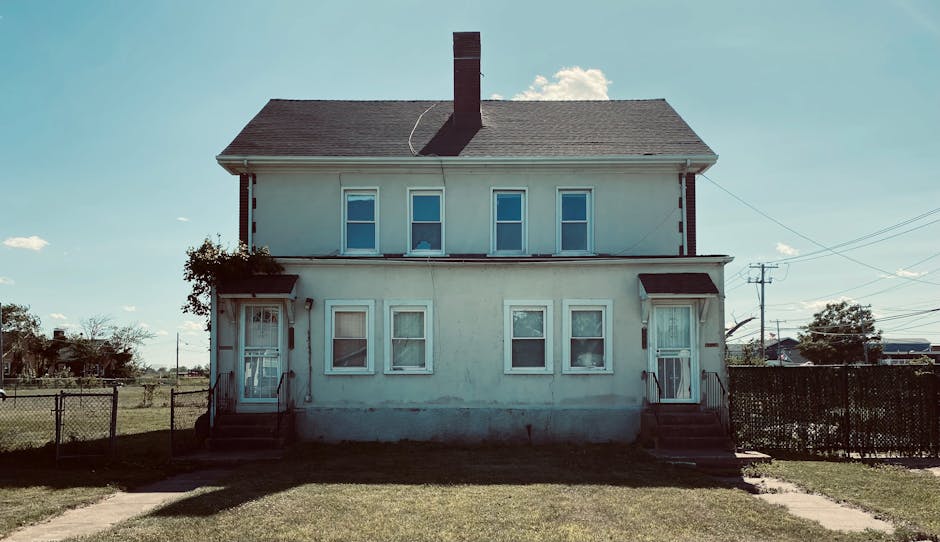 Classic two-story house with vintage exterior design under a clear blue sky.